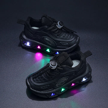 Black children's sneakers with colorful LED lights on a dark background