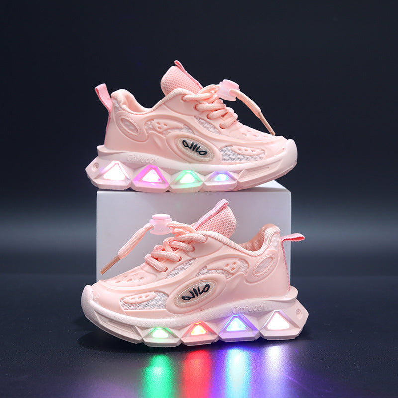 Pink children's sneakers with colorful LED lights on a dark background